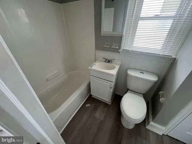 a bathroom with a sink a toilet and bathtub