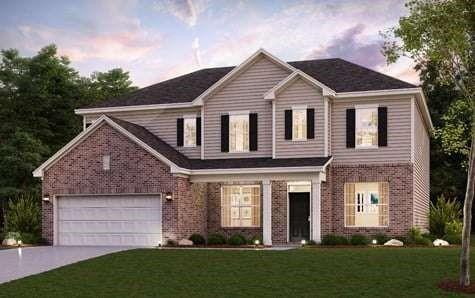 a front view of a house with a yard and green space