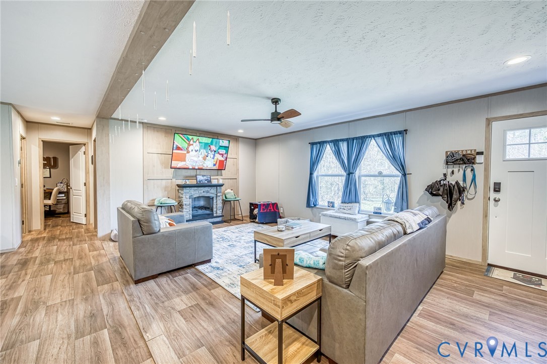6243 Studley Road Mechanicsville, VA 23116 - Photo 45 of 75 a living room with fireplace furniture and a wooden floor