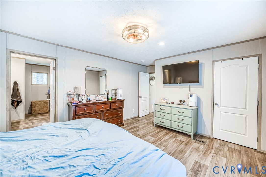 6243 Studley Road Mechanicsville, VA 23116 - Photo 56 of 75 a bedroom with a bed and a flat screen tv in it
