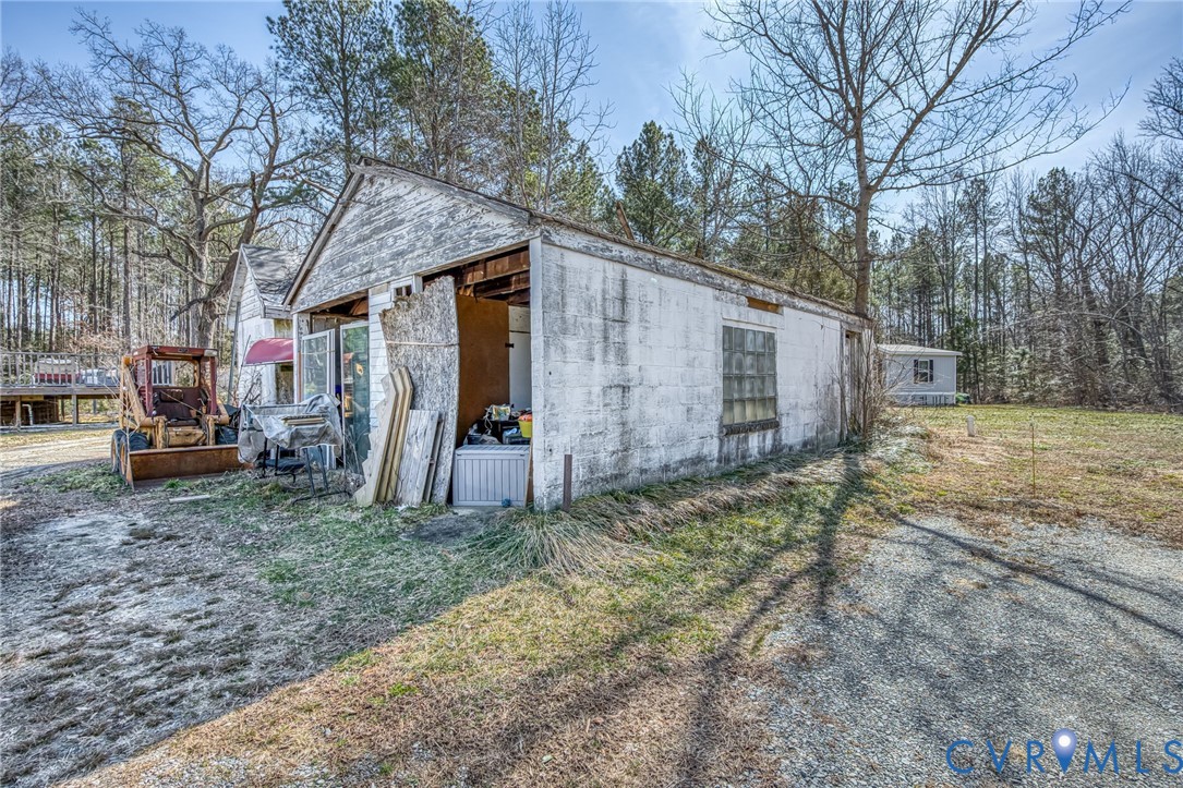 6243 Studley Road Mechanicsville, VA 23116 - Photo 74 of 75 a view of a barn in the backyard with large tree