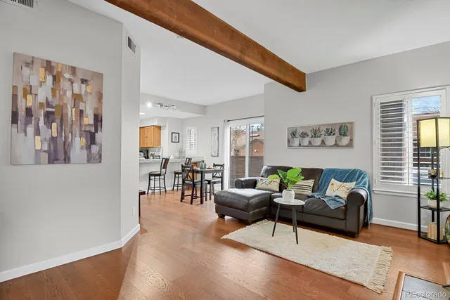 a living room with furniture and wooden floor