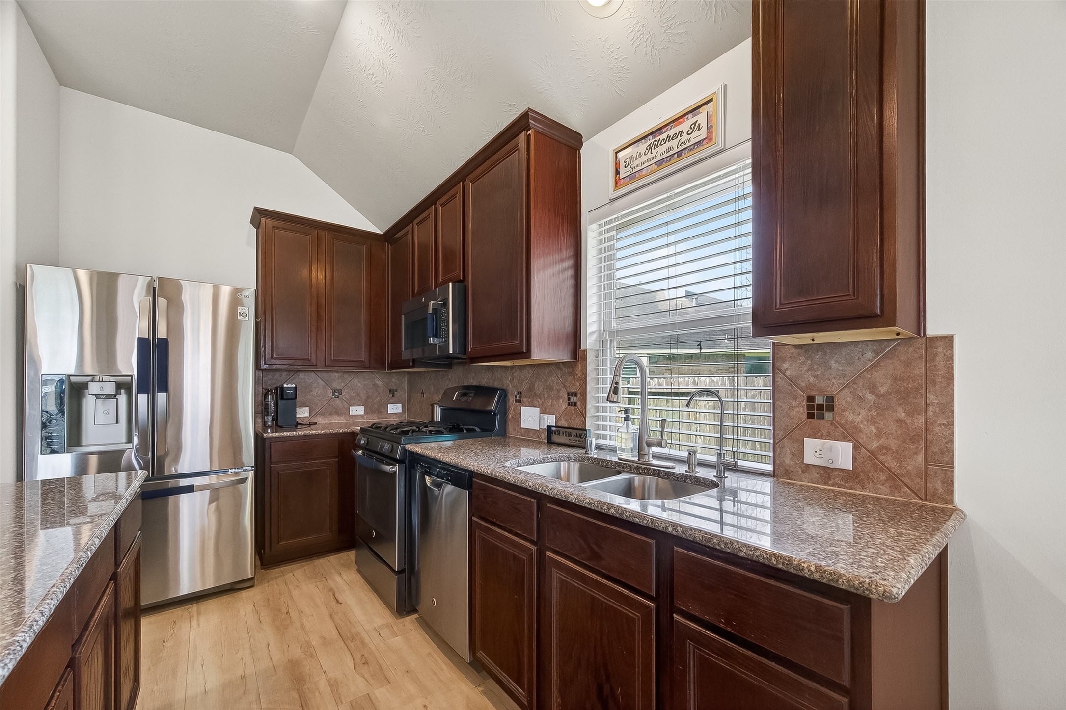 13415 Star Creek Lane Rosharon, TX 77583 - Photo 17 of 46 a kitchen with stainless steel appliances granite countertop a sink stove and refrigerator