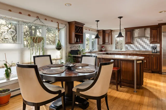 a living room with furniture and a dining table
