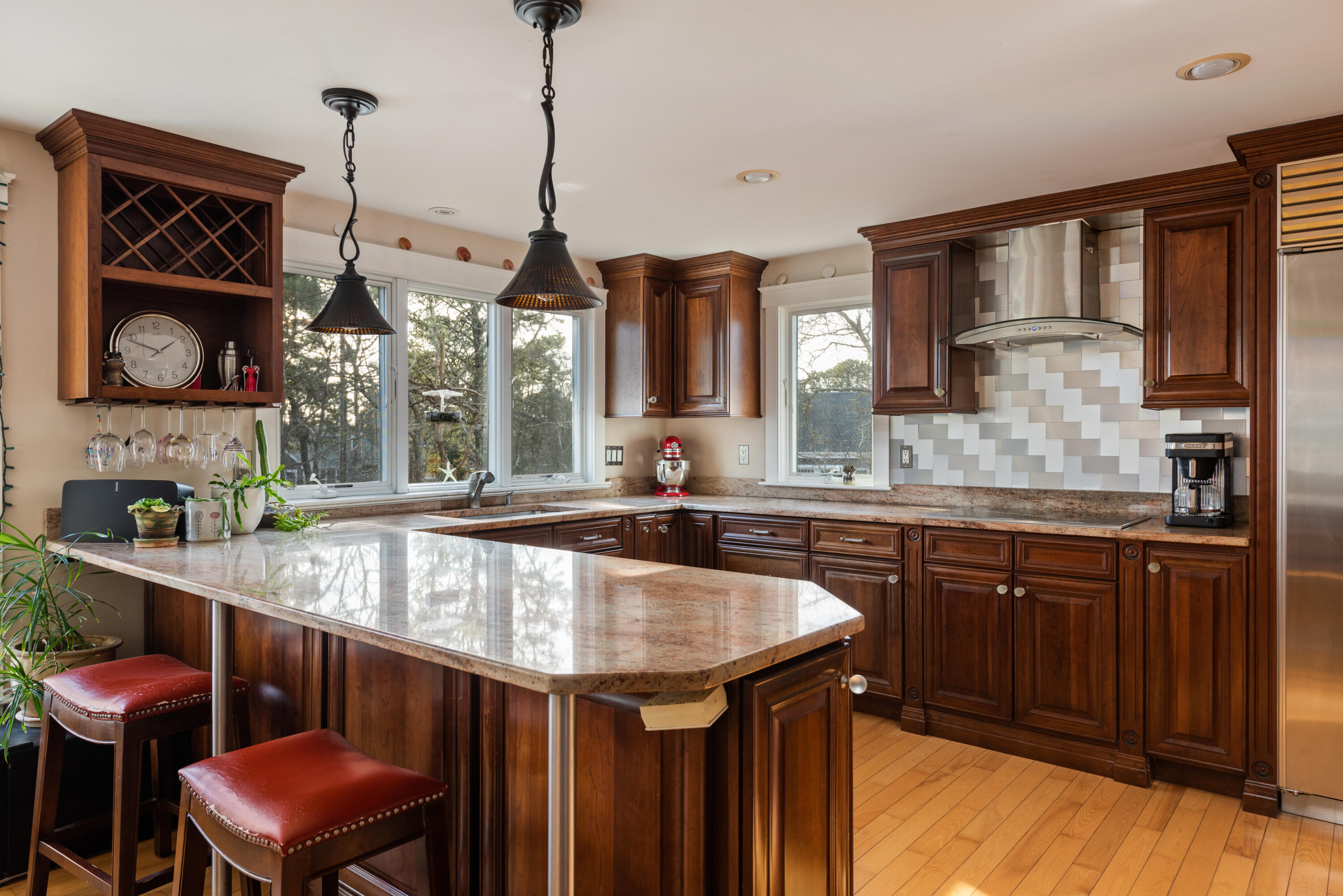 322 Pleasant Street Chatham, MA 02659 - Photo 17 of 39 a kitchen with a sink a center island and cabinets