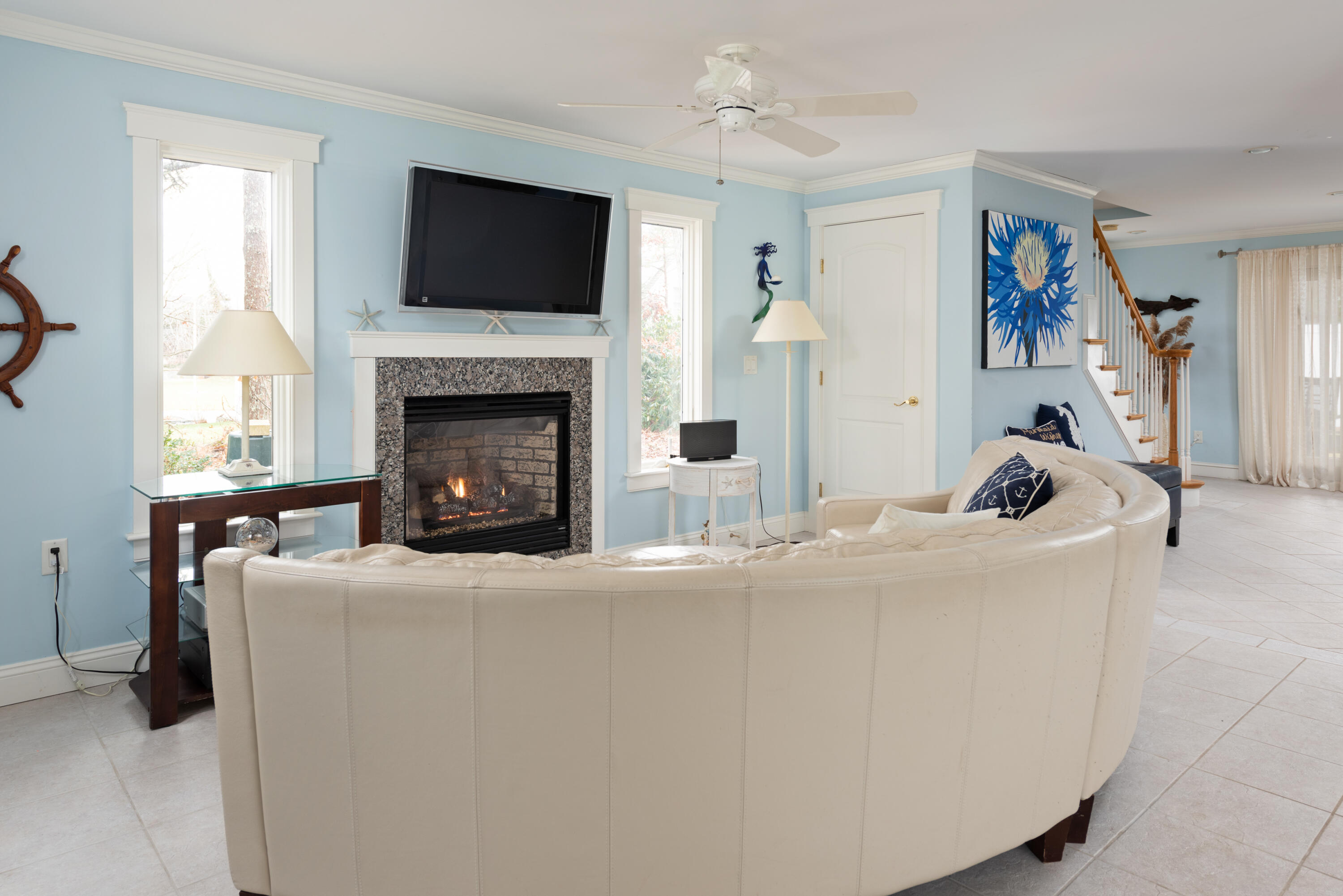 322 Pleasant Street Chatham, MA 02659 - Photo 7 of 39 a living room with furniture a flat screen tv and a fireplace