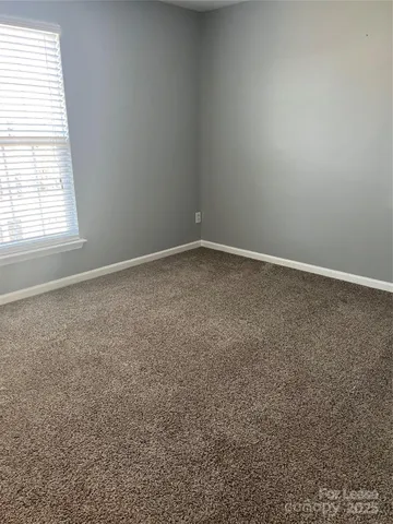 a white toilet sitting next to a bathroom sink and a mirror
