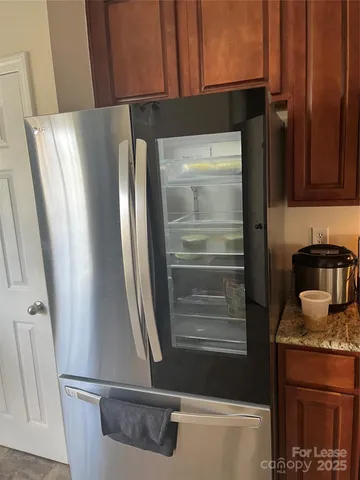 a kitchen with a refrigerator and a stove