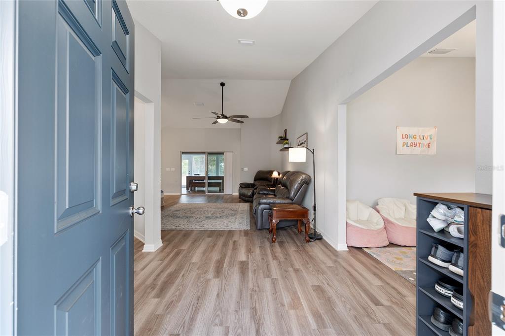 11275 Southwest 54th Circle Ocala, FL 34476 - Photo 11 of 63 a living room with furniture and a wooden floor