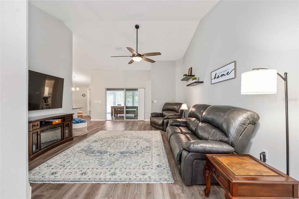 11275 Southwest 54th Circle Ocala, FL 34476 - Photo 13 of 63 a living room with furniture and a flat screen tv