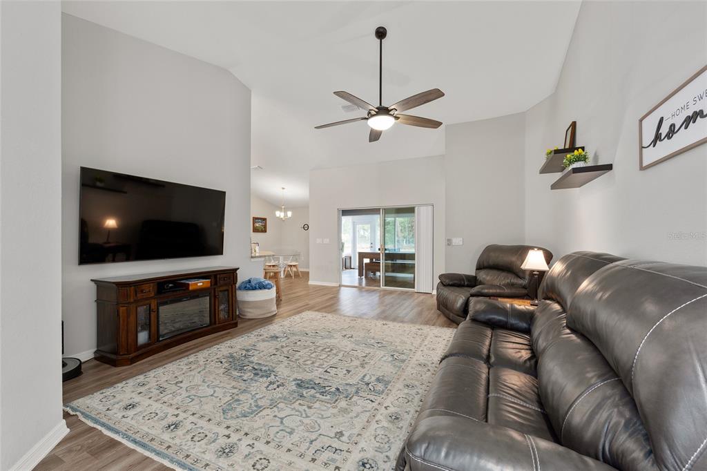 11275 Southwest 54th Circle Ocala, FL 34476 - Photo 14 of 63 a living room with furniture and a flat screen tv