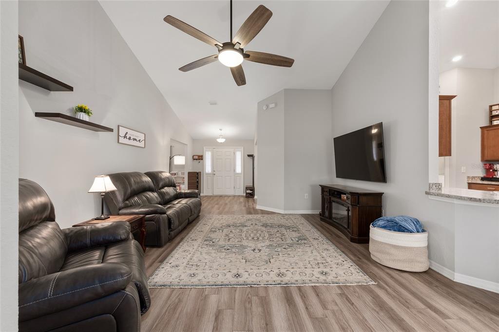 11275 Southwest 54th Circle Ocala, FL 34476 - Photo 15 of 63 a living room with furniture and a flat screen tv