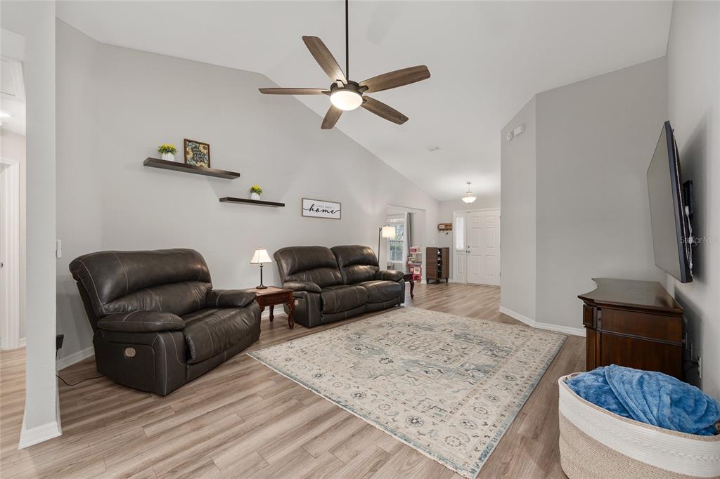 11275 Southwest 54th Circle Ocala, FL 34476 - Photo 16 of 63 a living room with furniture and a flat screen tv