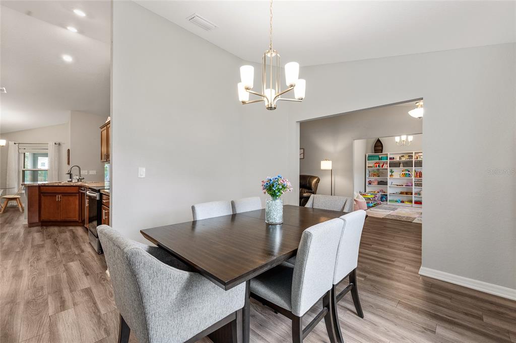 11275 Southwest 54th Circle Ocala, FL 34476 - Photo 20 of 63 a view of a dining room with furniture and wooden floor