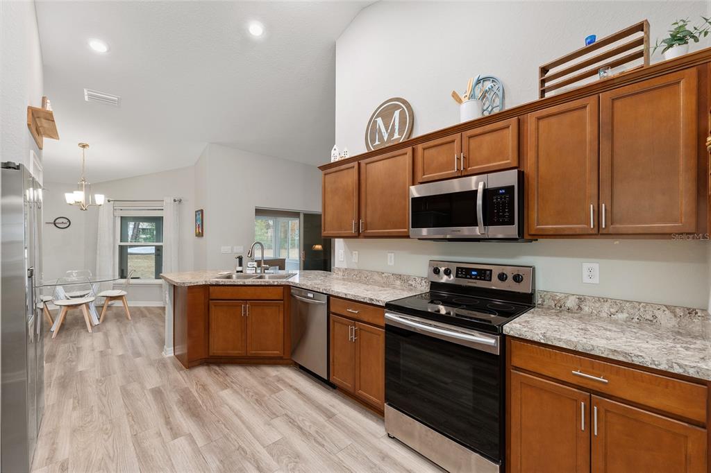 11275 Southwest 54th Circle Ocala, FL 34476 - Photo 25 of 63 a kitchen with stainless steel appliances granite countertop a stove and a microwave