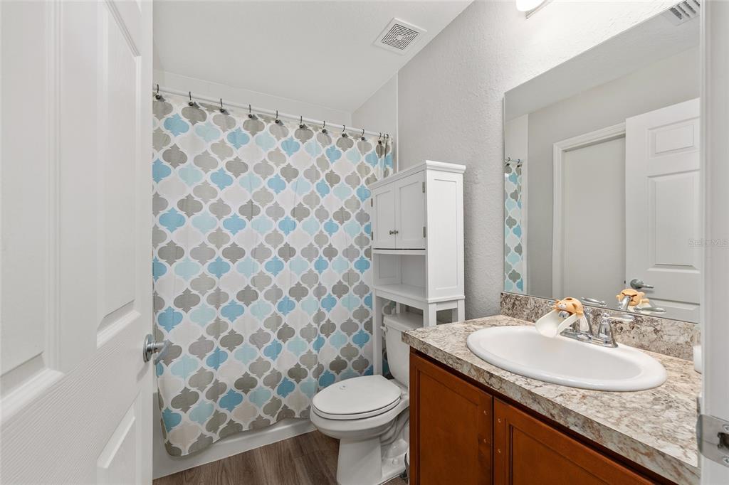 11275 Southwest 54th Circle Ocala, FL 34476 - Photo 29 of 63 a bathroom with a granite countertop toilet sink and mirror