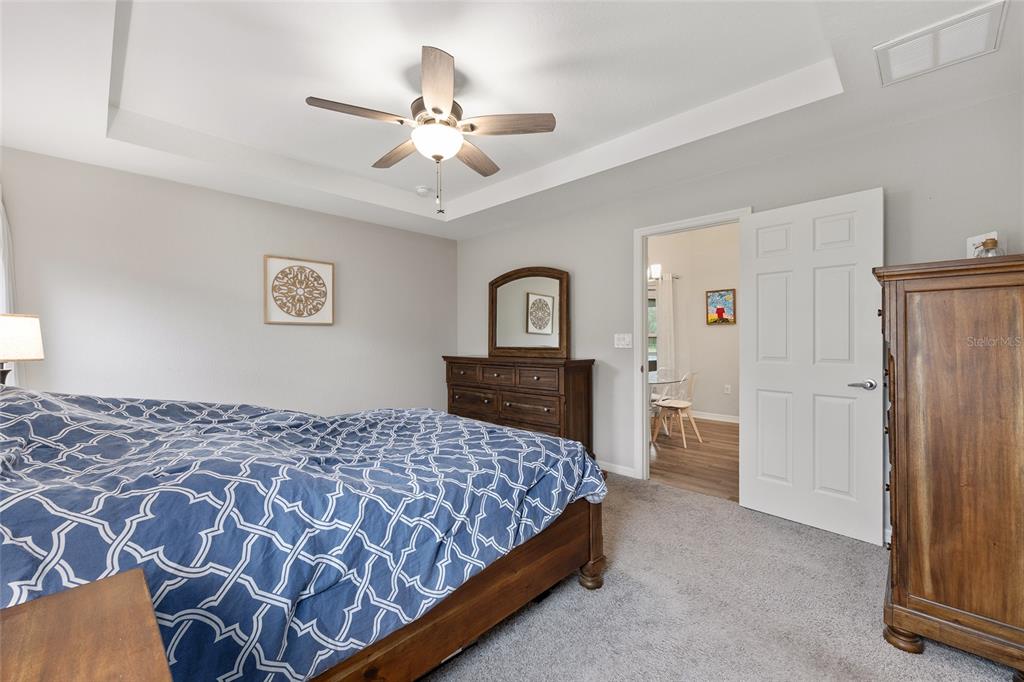 11275 Southwest 54th Circle Ocala, FL 34476 - Photo 36 of 63 a bedroom with a bed and a chandelier