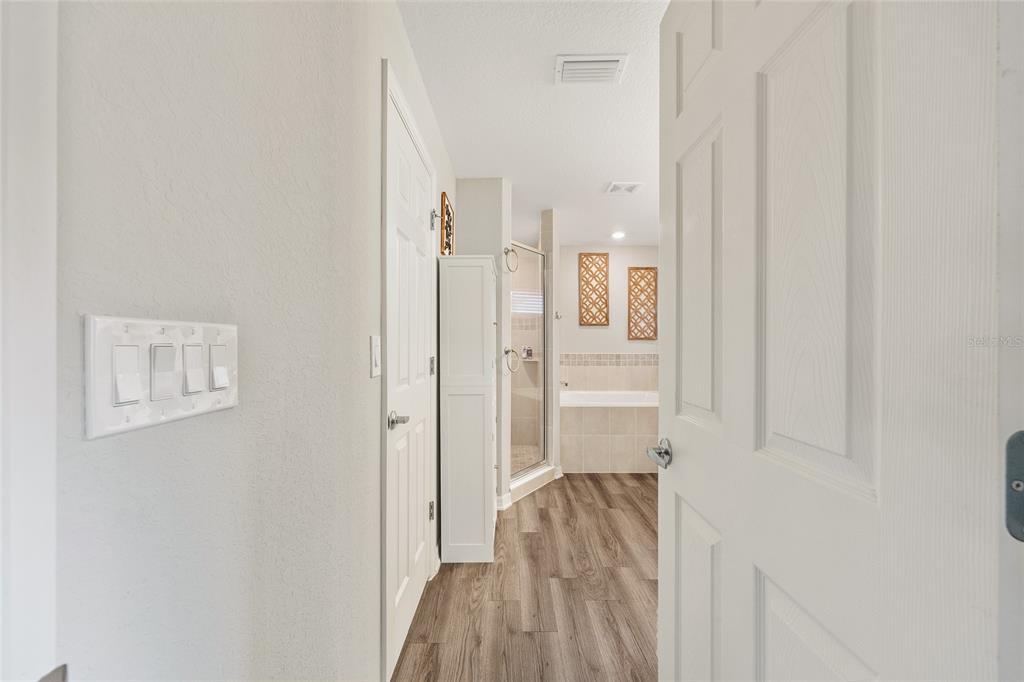 11275 Southwest 54th Circle Ocala, FL 34476 - Photo 37 of 63 a view of a hallway with wooden floor and closet area