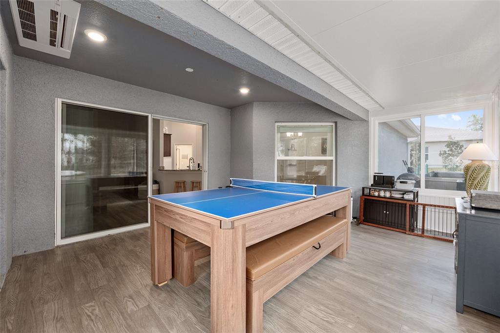 11275 Southwest 54th Circle Ocala, FL 34476 - Photo 43 of 63 a kitchen with kitchen island stainless steel appliances a stove refrigerator sink and wooden floor