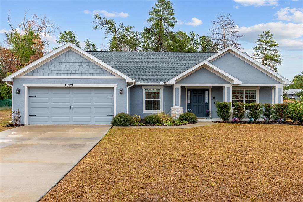 11275 Southwest 54th Circle Ocala, FL 34476 - Photo 6 of 63 a front view of a house with yard and green space