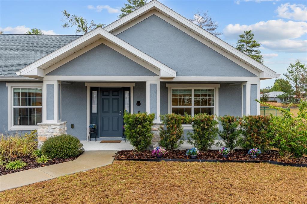 11275 Southwest 54th Circle Ocala, FL 34476 - Photo 8 of 63 a front view of a house with garden