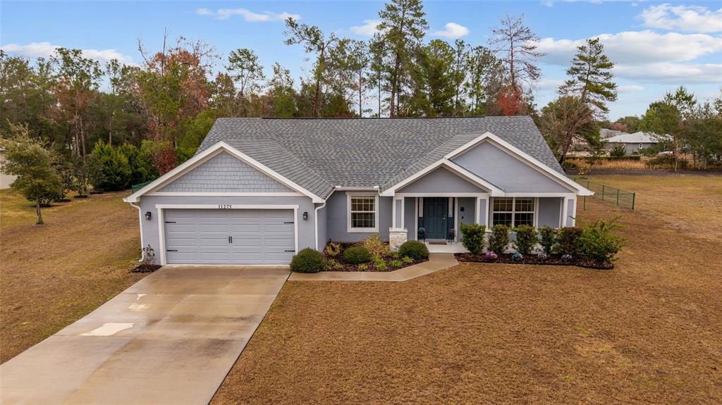 11275 Southwest 54th Circle Ocala, FL 34476 - Photo 10 of 63 a front view of a house with a yard