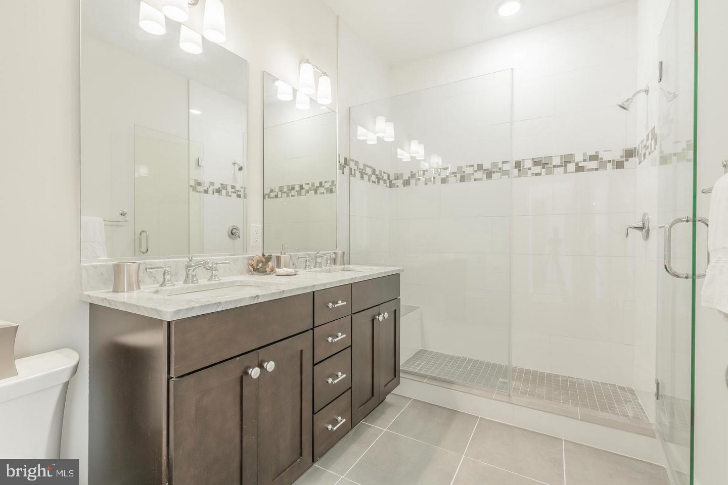 1352 Quincy Street Northwest, Unit 1 Washington, DC 20011 - Photo 15 of 26 a bathroom with a double vanity sink mirror and shower