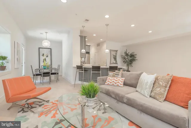 a living room with furniture and kitchen view