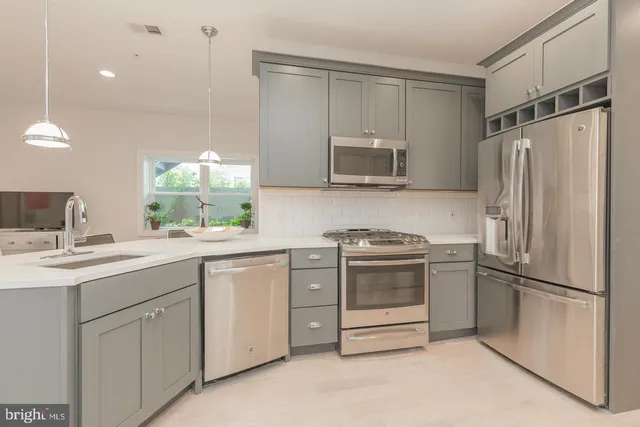 a kitchen with a sink stove and refrigerator