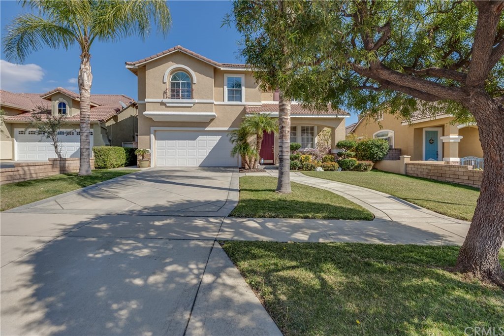 7171 Aloe Court Rancho Cucamonga, CA 91739 - Photo 1 of 1 a palm tree in front of a house with a yard