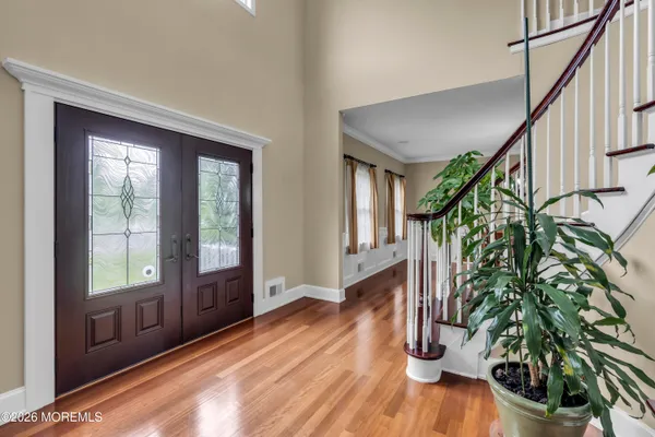 a view of an entryway with wooden floor and door