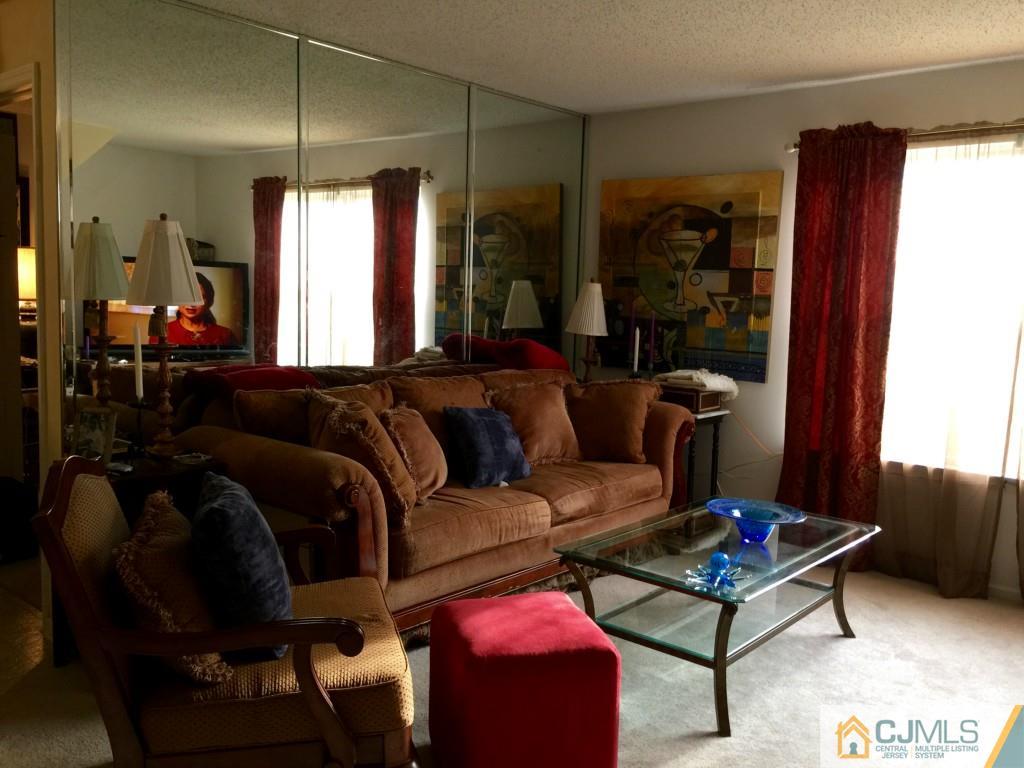 35 Inverness Drive Edison, NJ 08820 - Photo 2 of 15 a living room with furniture a lamp and a window