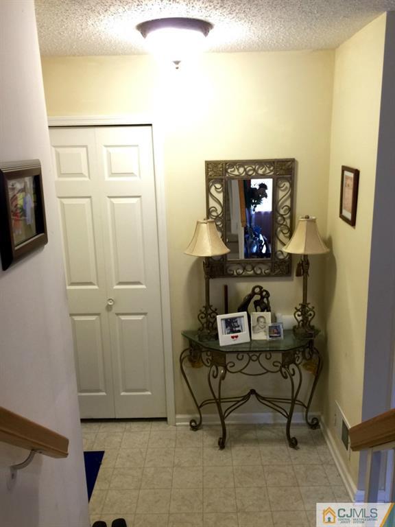 35 Inverness Drive Edison, NJ 08820 - Photo 13 of 15 a living room with furniture and a mirror