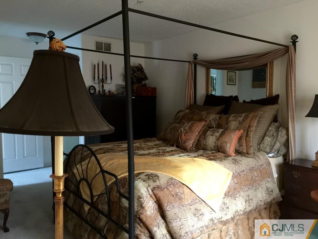 35 Inverness Drive Edison, NJ 08820 - Photo 8 of 15 a bed sitting in a bedroom next to a lamp