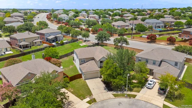 an aerial view of residential houses with outdoor space and street view