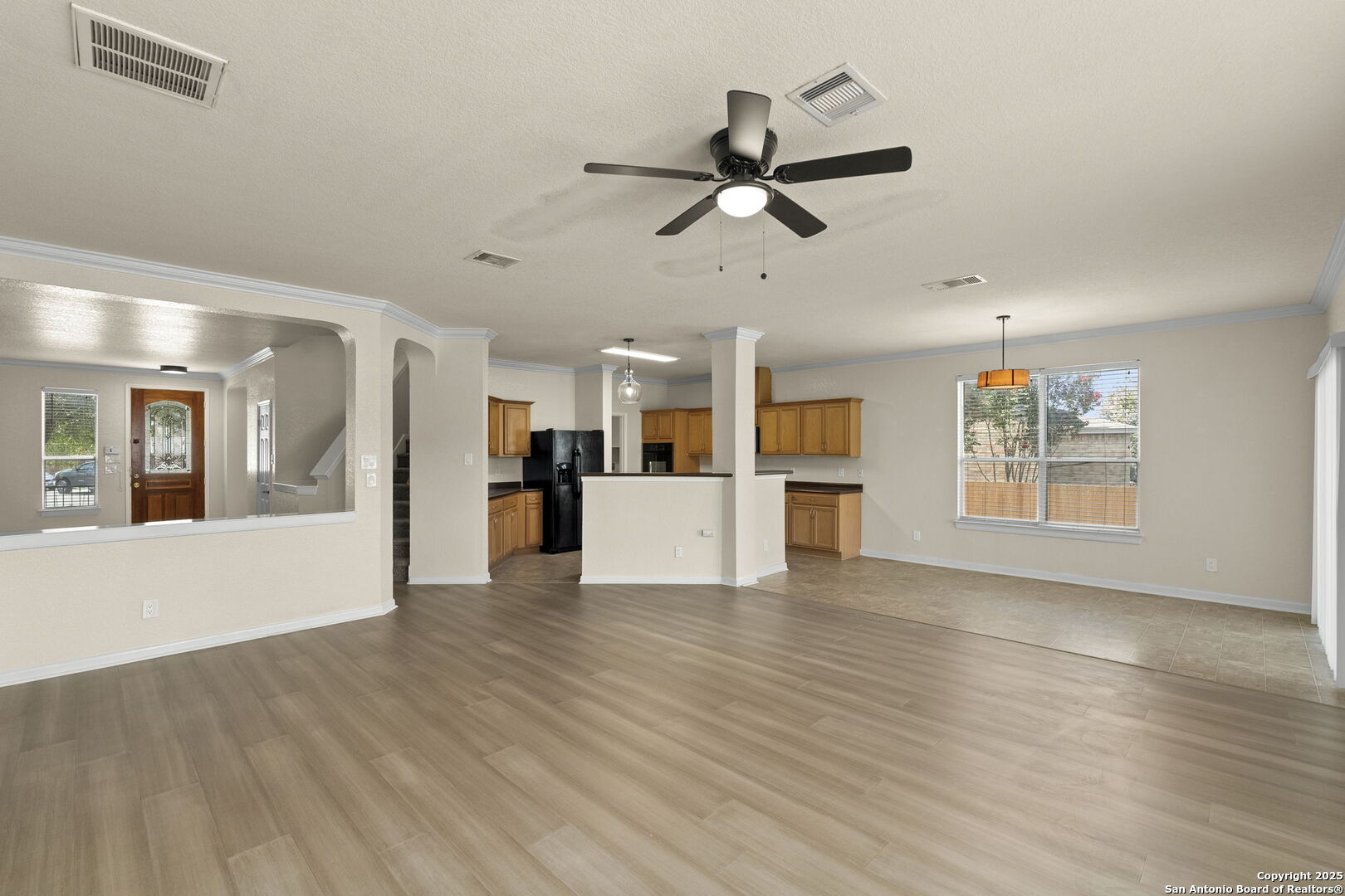213 Springtree Parkway Cibolo, TX 78108 - Photo 11 of 33 a view of a big room with wooden floor and a kitchen