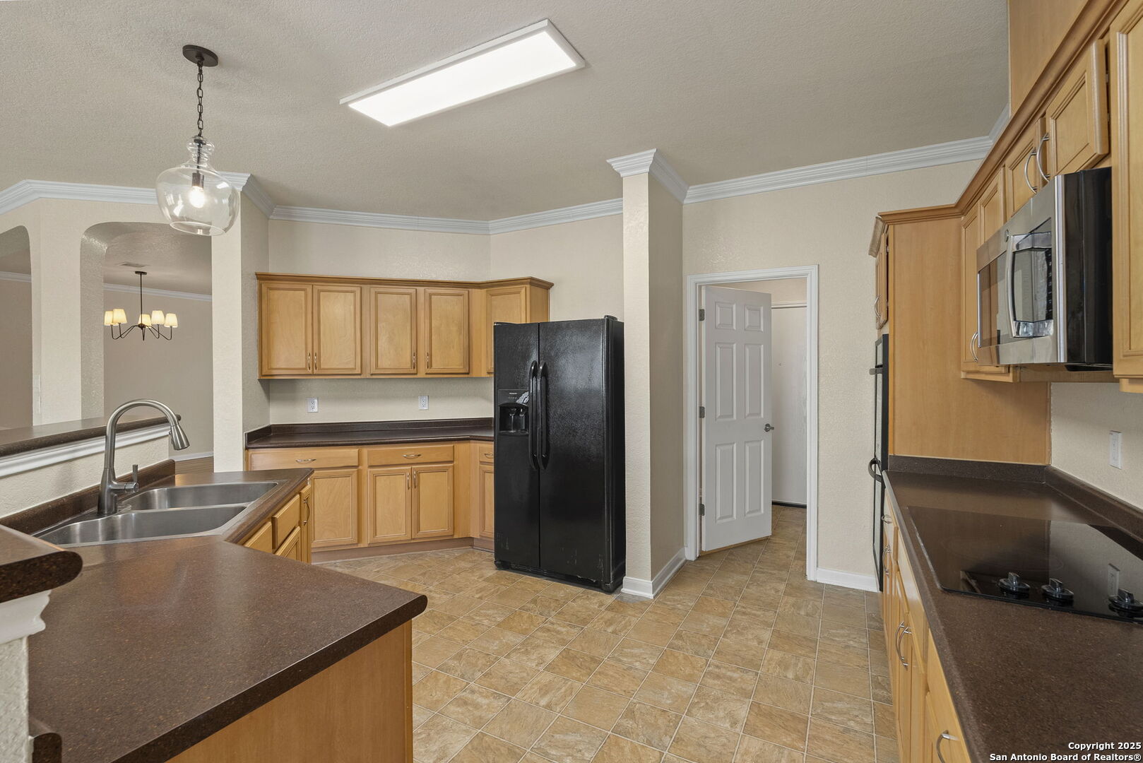 213 Springtree Parkway Cibolo, TX 78108 - Photo 15 of 33 a kitchen with stainless steel appliances granite countertop a refrigerator a sink and a stove