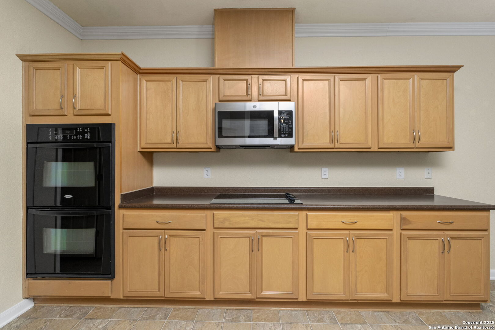 213 Springtree Parkway Cibolo, TX 78108 - Photo 18 of 33 a kitchen with granite countertop white cabinets and stainless steel appliances