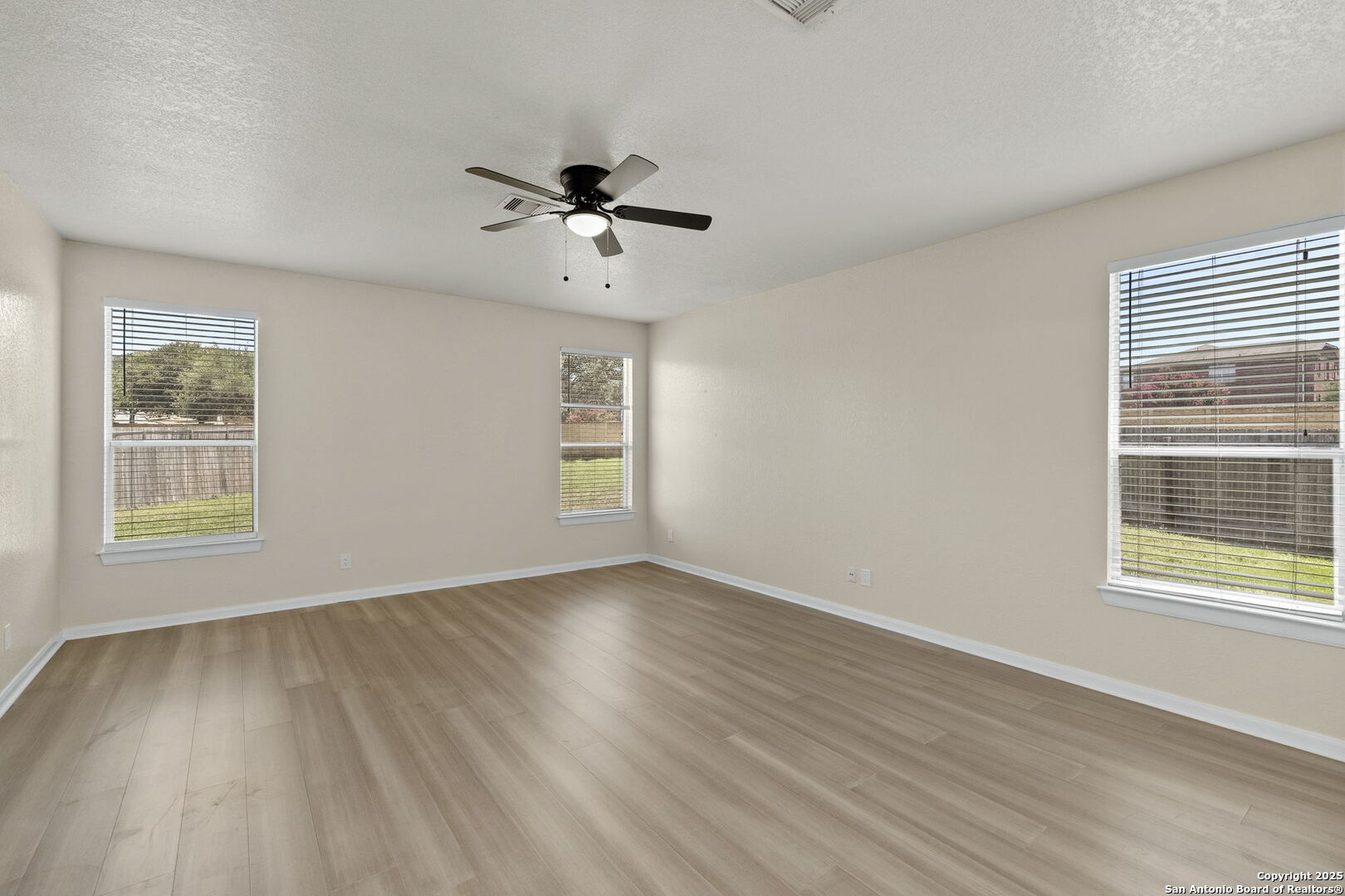 213 Springtree Parkway Cibolo, TX 78108 - Photo 20 of 33 a view of an empty room with a window and wooden floor