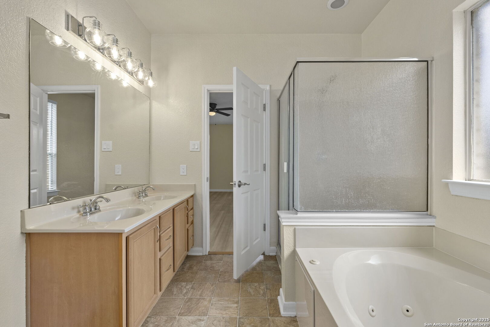 213 Springtree Parkway Cibolo, TX 78108 - Photo 23 of 33 a bathroom with a tub sink and mirror