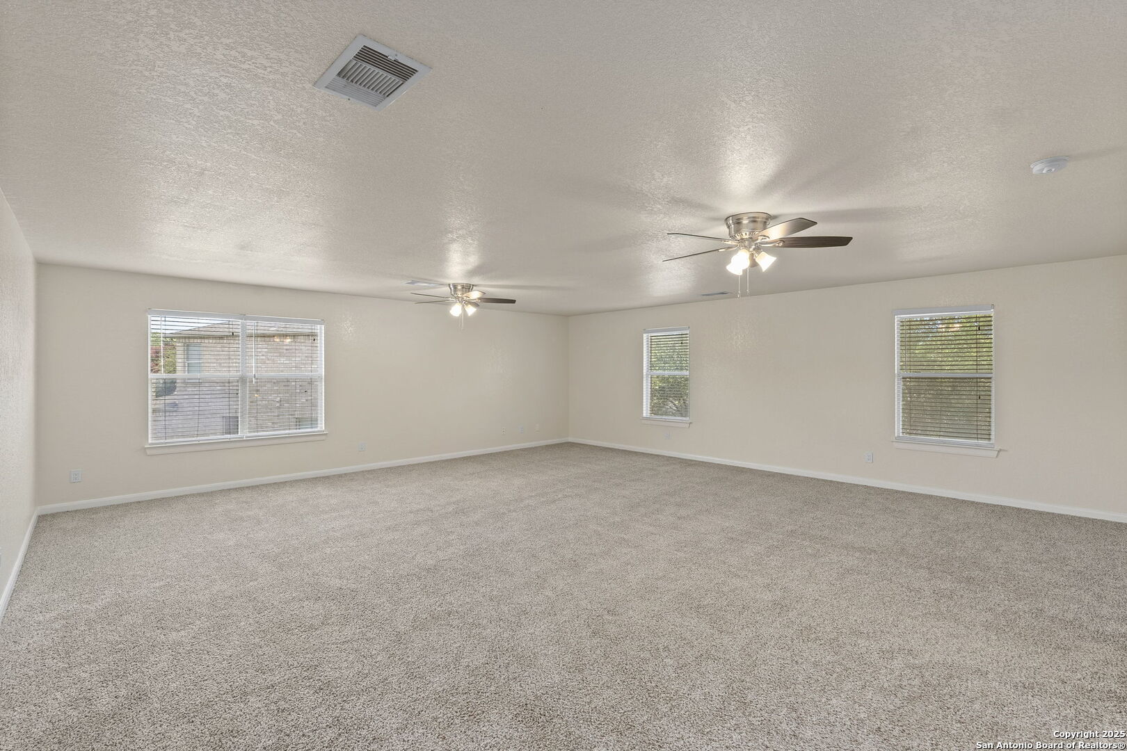 213 Springtree Parkway Cibolo, TX 78108 - Photo 24 of 33 a view of an empty room with a chandelier fan
