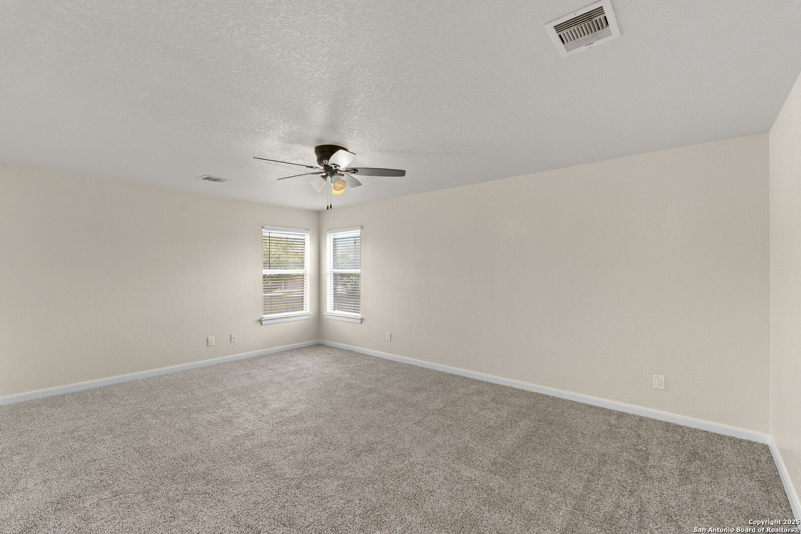 213 Springtree Parkway Cibolo, TX 78108 - Photo 26 of 33 an empty room with windows and chandelier fan