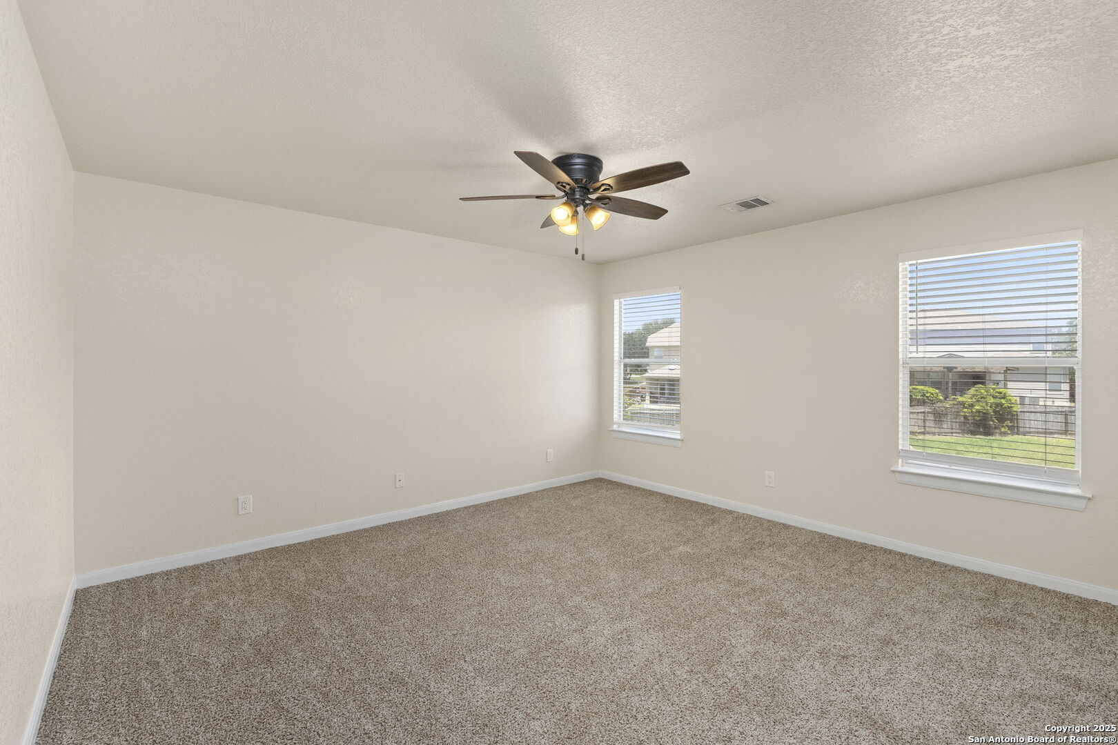 213 Springtree Parkway Cibolo, TX 78108 - Photo 30 of 33 an empty room with a window and a fan