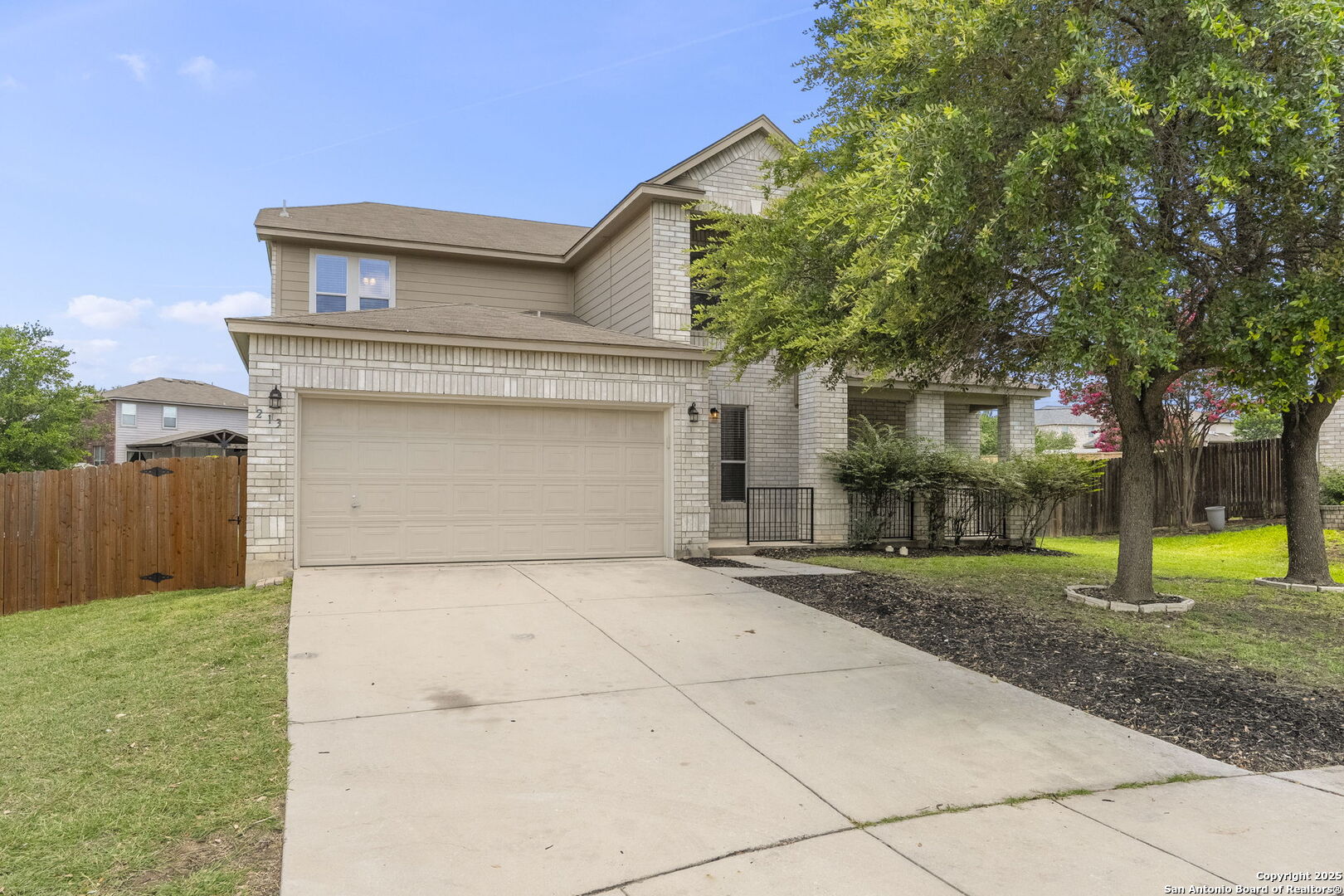 213 Springtree Parkway Cibolo, TX 78108 - Photo 5 of 33 a front view of a house with a yard and garage