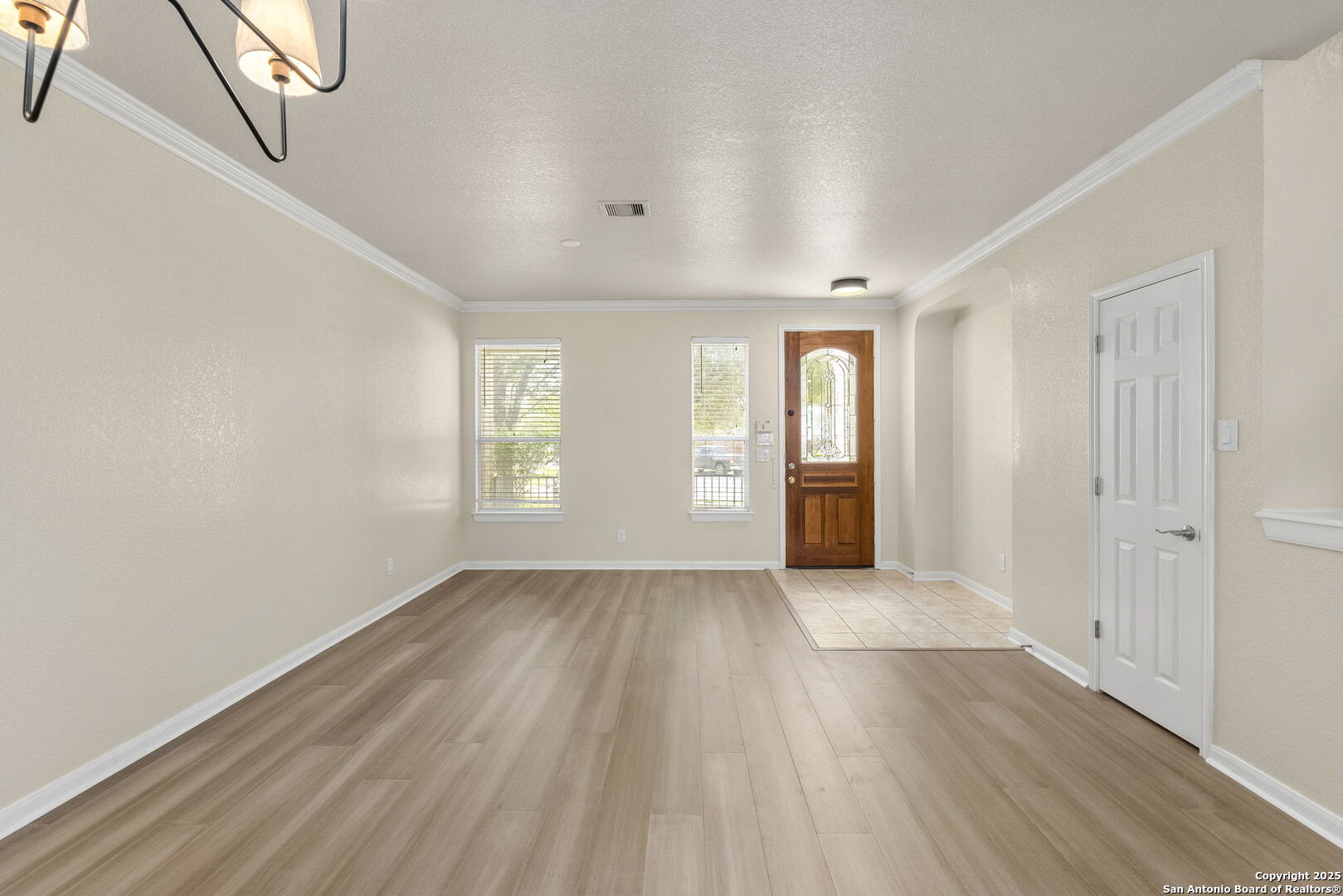 213 Springtree Parkway Cibolo, TX 78108 - Photo 8 of 33 wooden floor in an empty room with a window