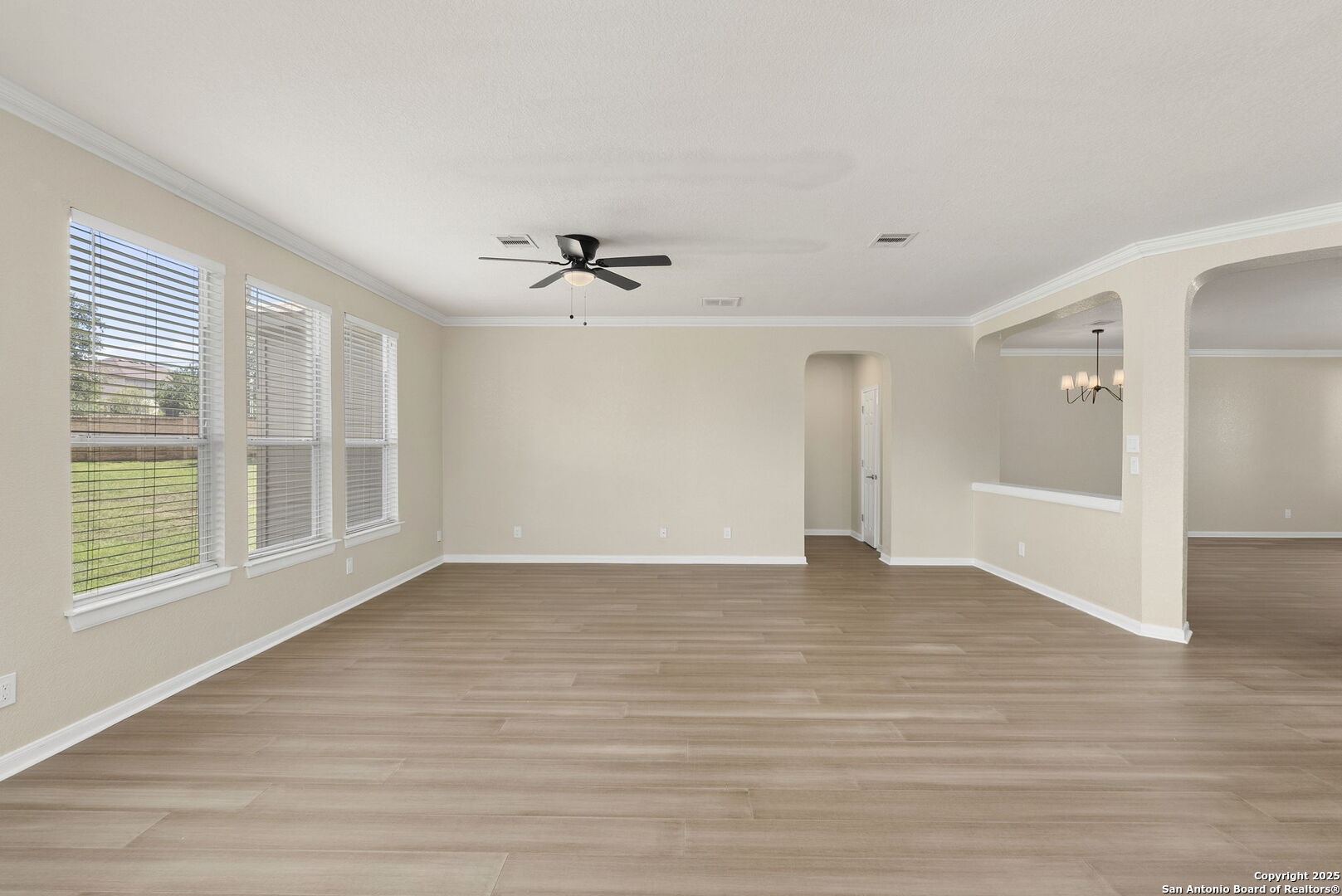 213 Springtree Parkway Cibolo, TX 78108 - Photo 9 of 33 a view of an empty room with a window and wooden floor