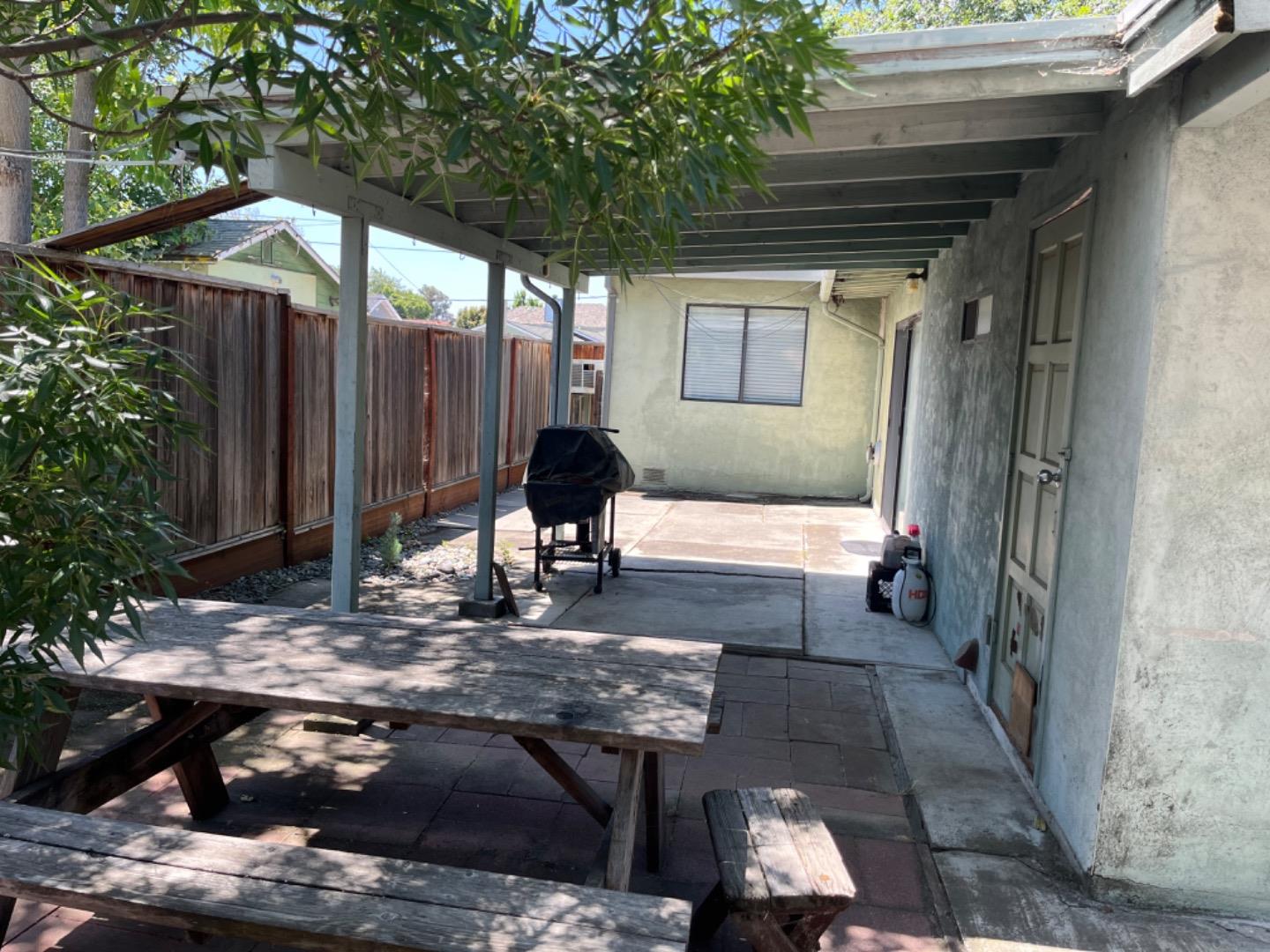 128 Laumer Avenue San Jose, CA 95127 - Photo 1 of 18 a view of a patio with table and chairs with wooden fence and floor