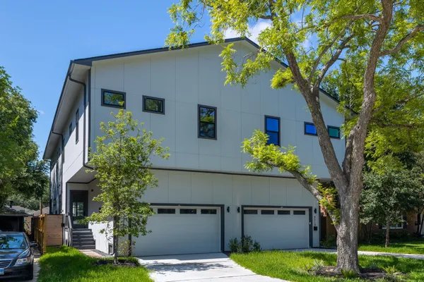 a house that has a tree in front of it