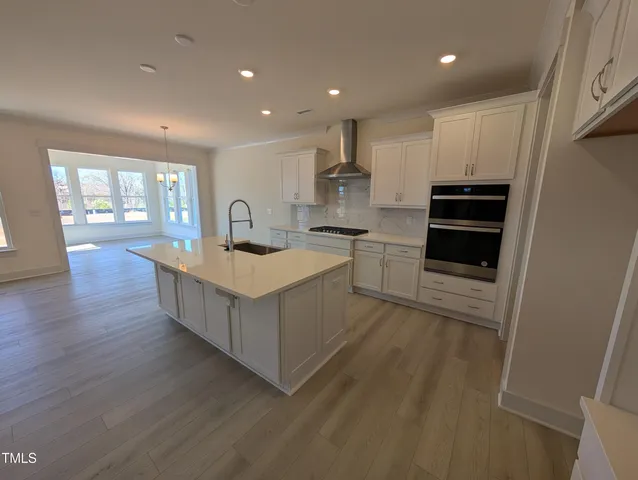 a kitchen with kitchen island sink stove and cabinets