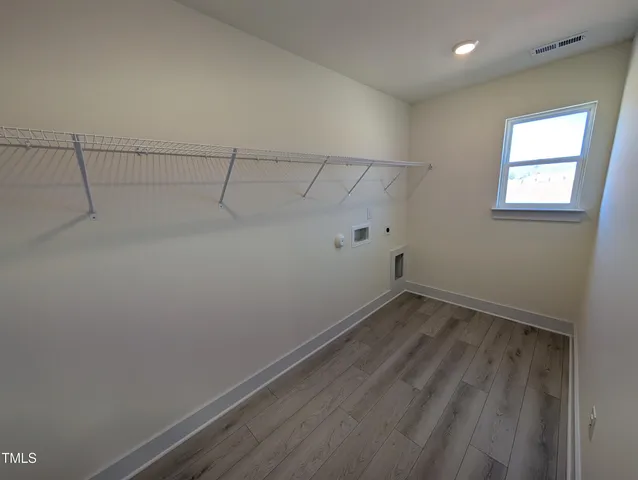 an empty room with windows and closet
